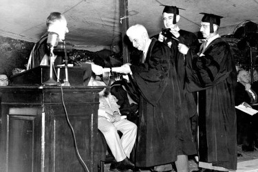Arthur Oncken Lovejoy receives an honorary diploma from George Boas during  1951 commencement ceremony.
