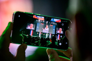 A phone recording a video of a politician giving a speech.