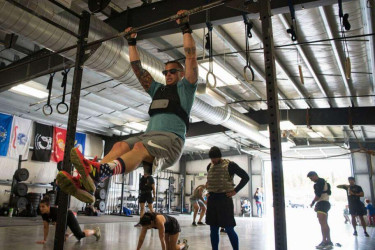 Military members exercising at a CrossFit gym.