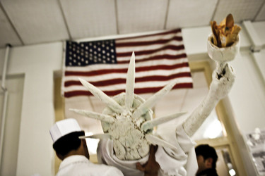 Kitchen workers moving a paper-mache Statue of Liberty in 2009 Kabul, Afghanistan.