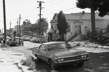 Children watch as a house is bulldozed in West Oakland