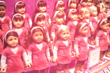 American Girl dolls in a display booth.
