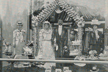 Shop window decorated with bride and groom mannequins and wedding paraphernalia, from Baum's "Show Window" magazine.