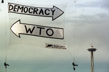 A WTO protest banner in front of the Space Needle in Seattle.