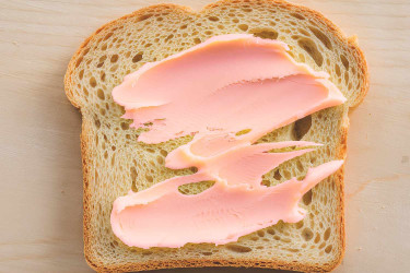 Pink maragine smeared on bread.