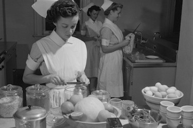 Nurses prepare food in a hospital kitchen.