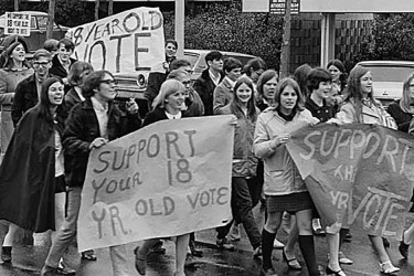 Protesters marching with a sign in support of the Twenty-sixth Amendment