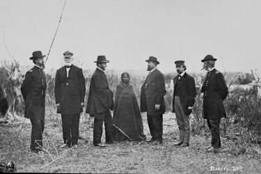 Lakota child Sophie Mousseau among a line of U.S. peace commissioners.