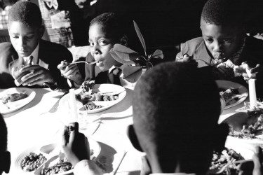 Children eating Thanksgiving dinner in Harlem.