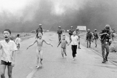 "Napalm Girl" or "Terror of War" photograph credited to Nick Ut shows Kim Phuc and Vietnamese children running after their village was bombed with napalm in the Vietnam War.