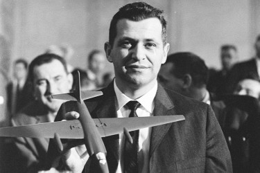 Francis Gary Powers holding a model U-2 plane.