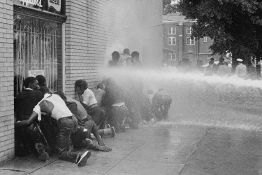 Police turn fire hoses on nonviolent youth civil rights demonstrators in Alabama.
