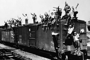 Bonus Army veterans heading to Washington, D.C., on the outside of a freight train, 1932.