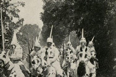 Robed Ku Klux Klan members on horseback, in a scene from "Birth of a Nation."