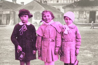 Three young kids standing in a European town