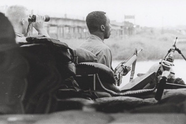 Black soldier with a machine gun.