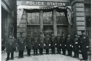 Police officers standing outside the Arlington, Massachusetts police station, around the turn of the 20th century.
