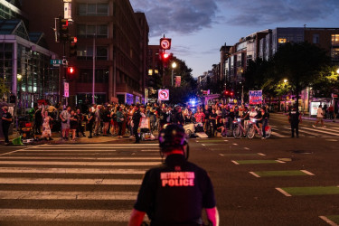 A Metropolitan Police Department officer watching demonstrators during a “Free D.C.” protest, Washington, D.C., August 2025.