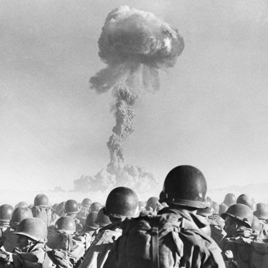 Soldiers watching a nuclear explosion.