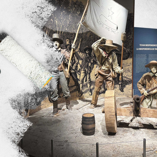 A person white washing over a Texan Independence exhibit.