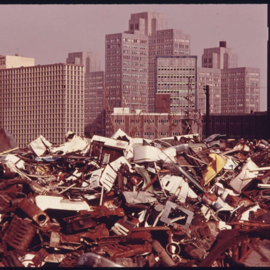 The Pittsburgh skyline with a pile of trash in the foreground, 1974.