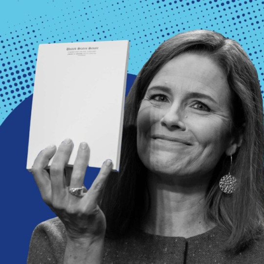 Amy Coney Barrett holding a senate report.