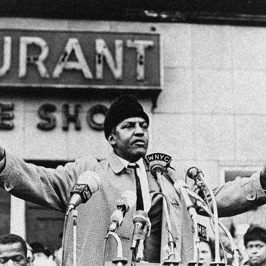 Bayard Rustin speaking in front of a crowd