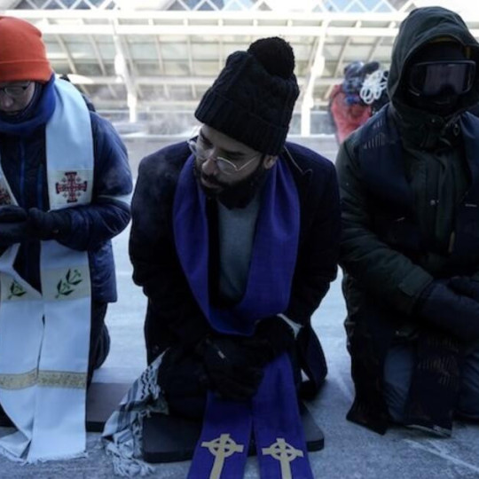 Clergy members kneel as they take part in the general strike in Minneapolis to protest ICE.