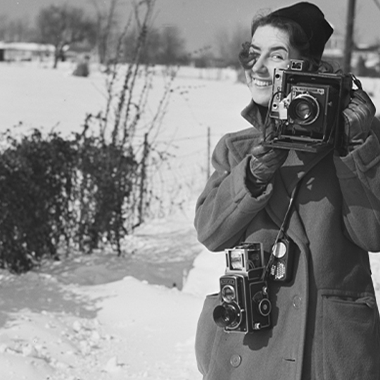 Marion Post Wolcott holding a camera.
