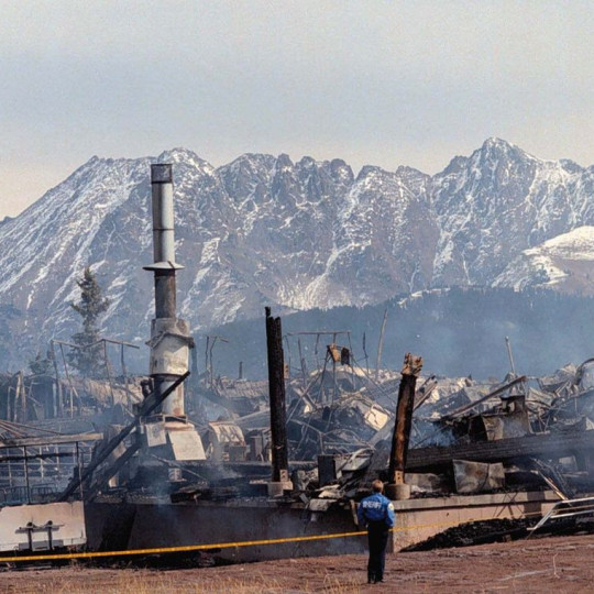Destroyed infrastructure in front of a mountain.