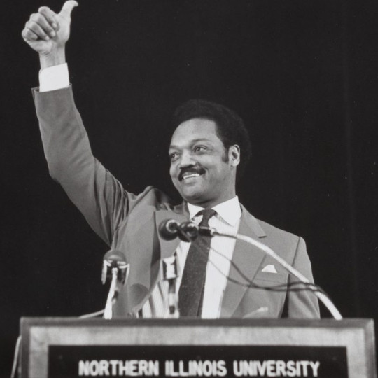 Jesse Jackson speaking at a podium