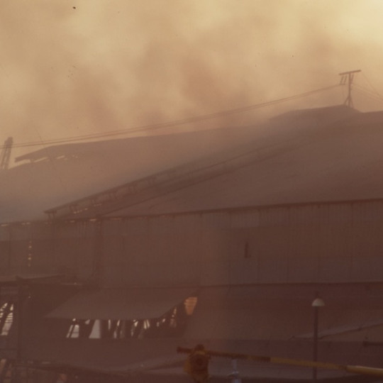 Clouds of pollution hang over a building.