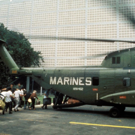 Civilian evacuees board a helicopter inside the U.S. Embassy in Saigon on April 30, 1975