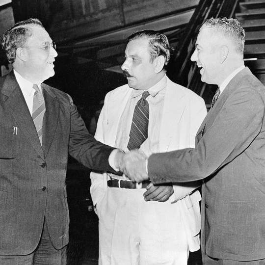 Rexford Tugwell shaking hands with the former acting governor of Puerto Rico in front of Luis Muñoz Marín.