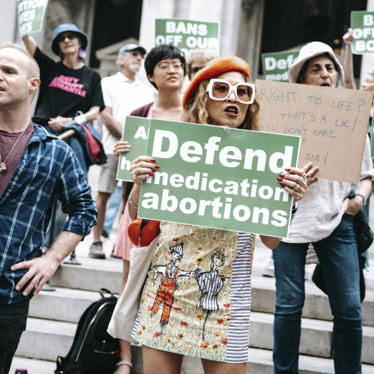 Abortion rights activists demonstrate in New York in 2023, holding signs defending abortions.