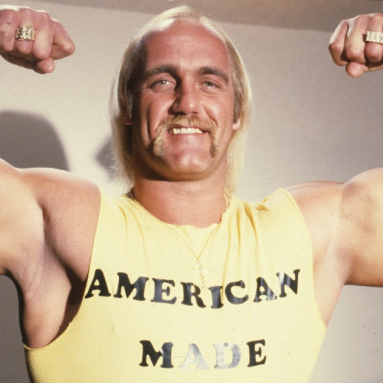 Hulk Hogan flexing his arms.