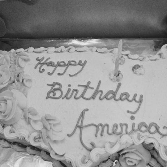 A cake in the shape of the continental US with the words, 