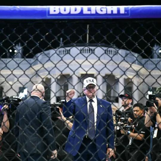 President Donald Trump stands in The Octagon at the conclusion of the 