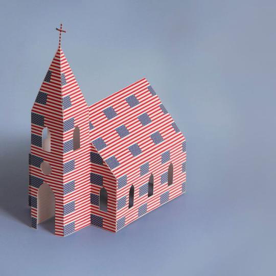 A folded paper church with American flags printed all over it.