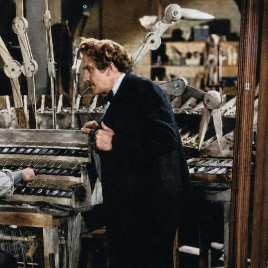 Twain visiting Paige and his machine, as depicted in the 1944 film The Adventures of Mark Twain (colorized).