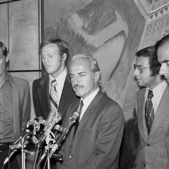 Baseball owner gives a press conference.