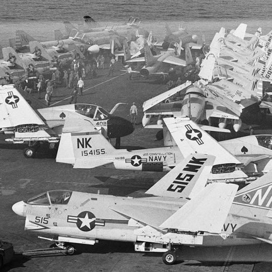 Navy airplanes on an aircraft carrier.