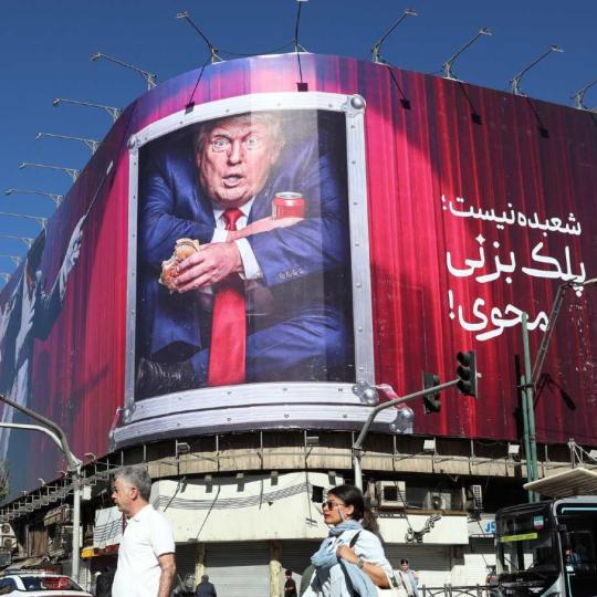 Iranians walk past an anti-Trump billboard along a street in Tehran on September 23, 2026.