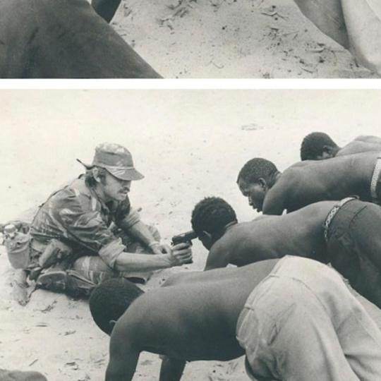 Rhodesian soldier interrogating villagers in late 1977 at gunpoint
