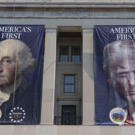 Posters of Washington and Trump hanging on a building in Washington DC.