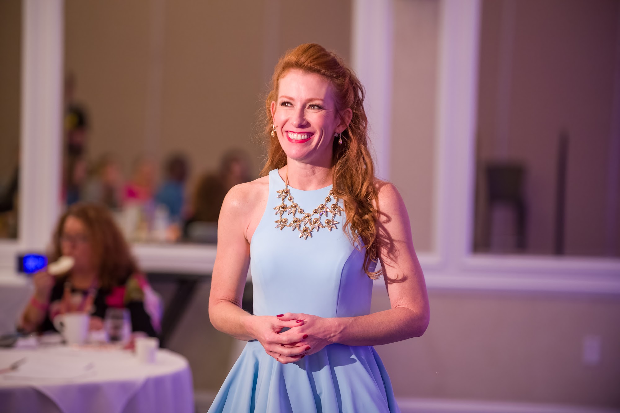 Tamara Rose smiling in a light blue dress