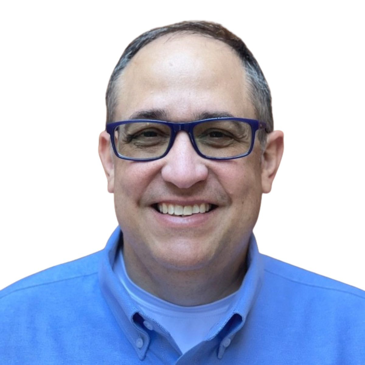 A man with glasses and a blue shirt smiles at the camera against a white background.