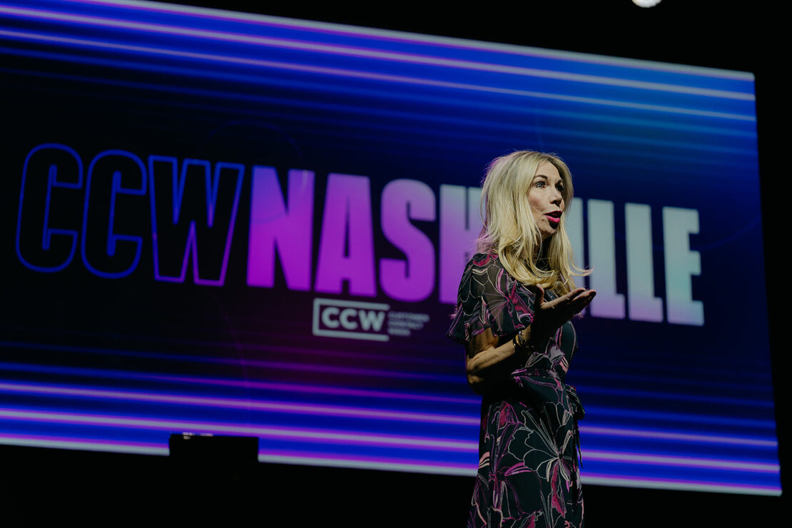 A woman speaks on stage in front of a large screen displaying "CCW Nashville" in bold letters.