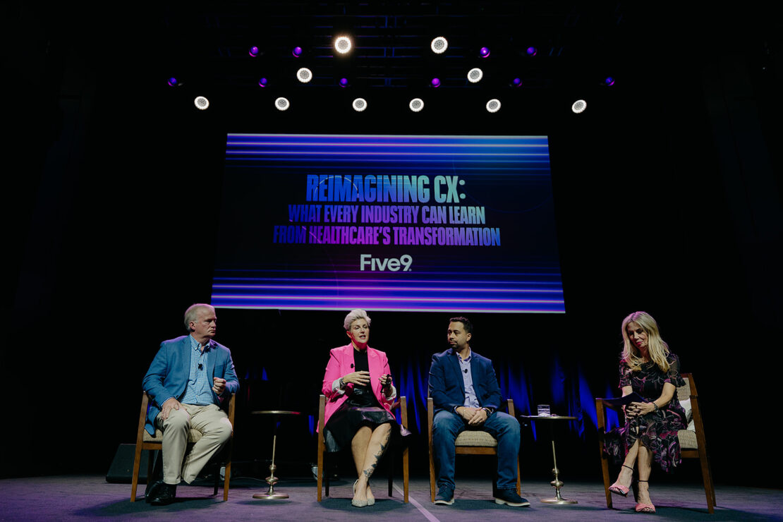 Four panelists sit on stage under a screen displaying the text "Reimagining CX: What Every Industry Can Learn from Healthcare's Transformation. Five9.
