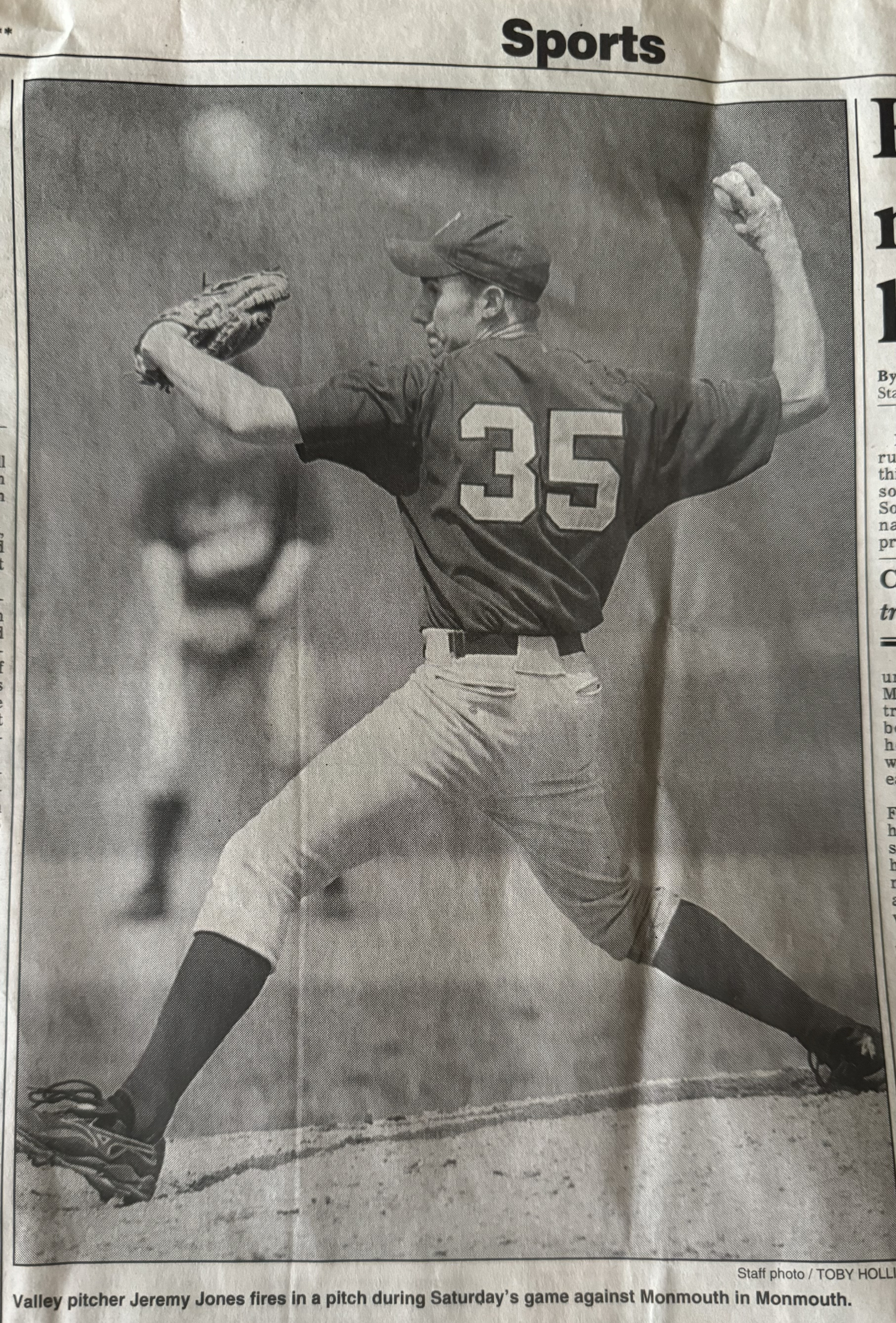A newspaper clipping of a teenage boy pitching in a baseball game